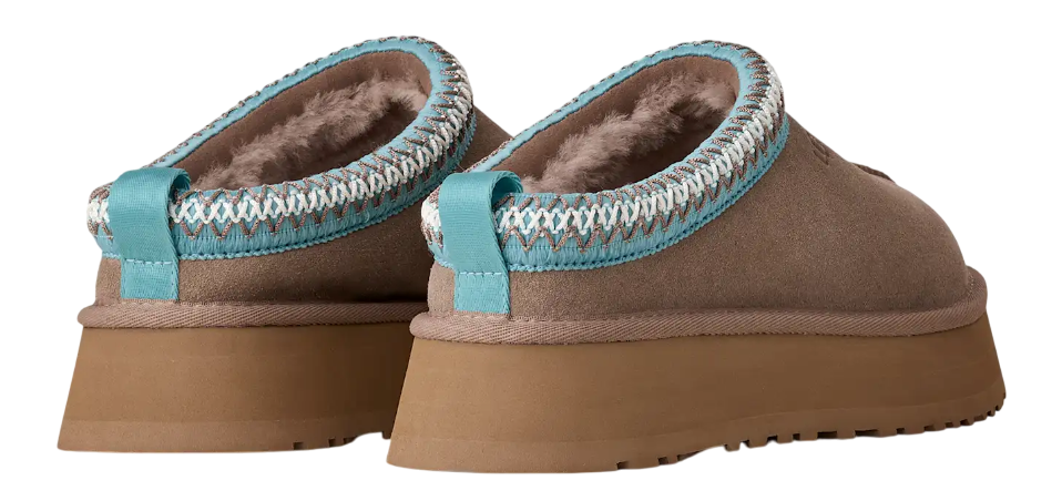 Pair of brown slippers with turquoise trim on a white background
