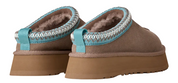 Pair of brown slippers with turquoise trim on a white background