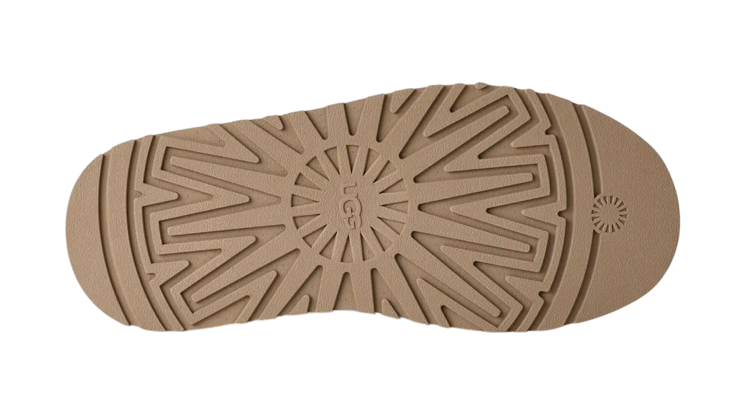 Close-up of a brown shoe sole with a pattern on a white background