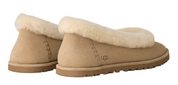 Pair of tan UGG slippers with sheepskin lining on a white background