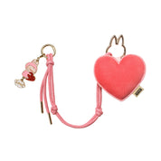 Heart-shaped pink pouch with a keychain on a white background