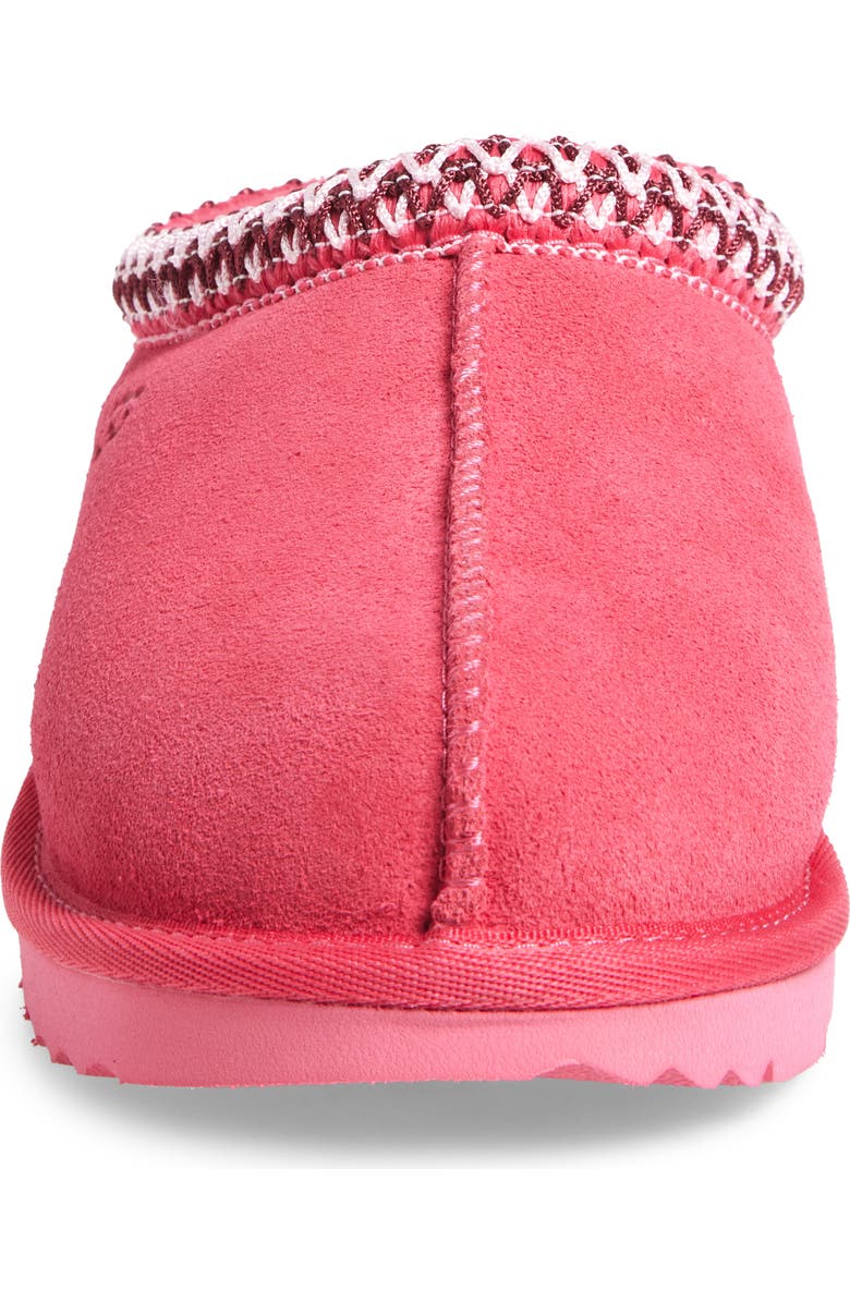 Pink slip-on shoe with a textured sole on a white background
