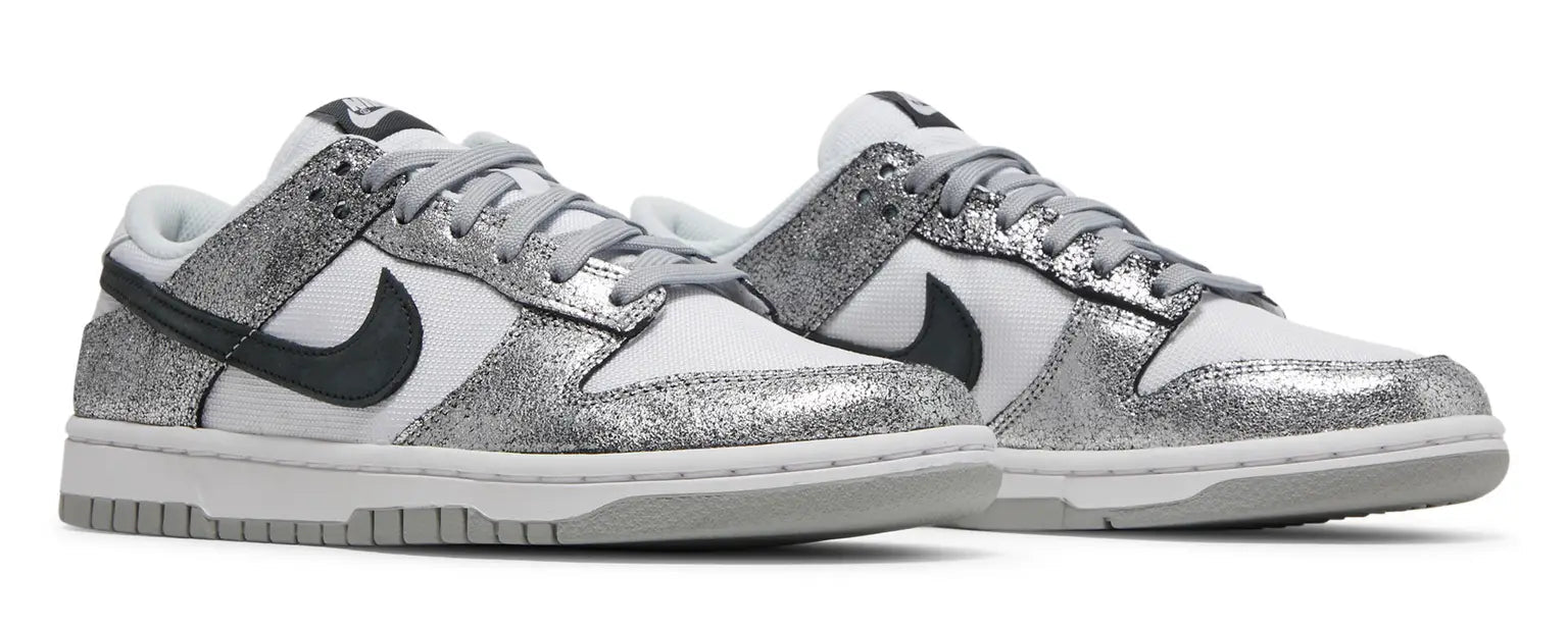 Silver glitter sneakers with black swoosh logo on a white background