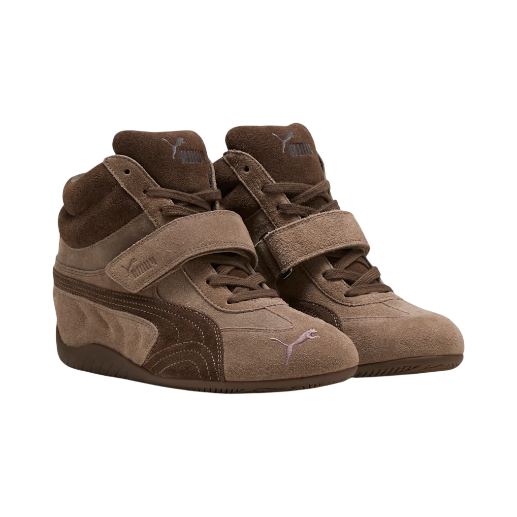 Pair of brown Puma sneakers with velcro straps on a white background