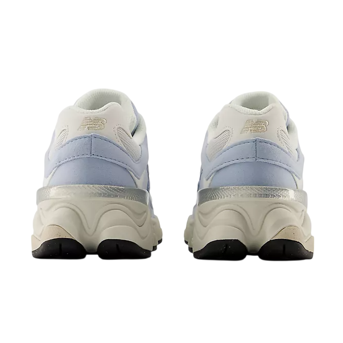 Pair of white sneakers with light blue accents on a white background