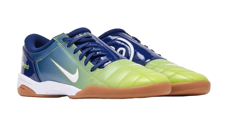 Pair of blue and green sports shoes on a white background